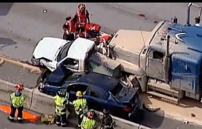 A pickup truck and passenger car were pinned agains the westbound lane barrier Monday afternoon