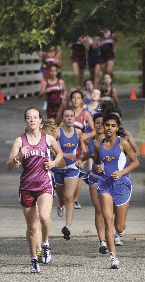 Members of the Mercer Island and Bellevue cross country teams speed through the second lap of the triple meet between the Islanders