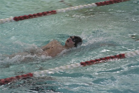 Samuel Chong finishes the final lap of the backstroke in the 200 individual medley race last Tuesday during the Islanders’ home win over Bellevue.