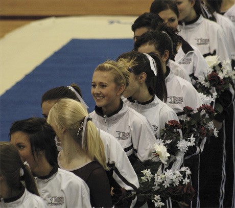 Senior gymnastics captain Rachel Pedreira stands with her team during the opening moments of the Islanders’ first and last home meet of the season last Thursday. The Islanders finished third behind Olympic and Inglemoor.