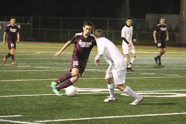 Mercer Island’s Sean Bender dribbles past Interlake’s Austin Ball Friday