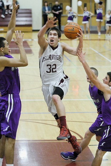 Islander guard Sean Hughes (32) drives against Lake Washington during a game at Mercer Island on Tuesday.