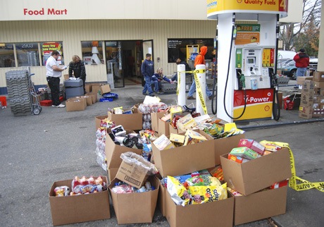 Boxes of mini-mart products sit outside the Shell station on 78th Avenue S.E. on Dec. 4. Employees worked all day to empty the convenience store