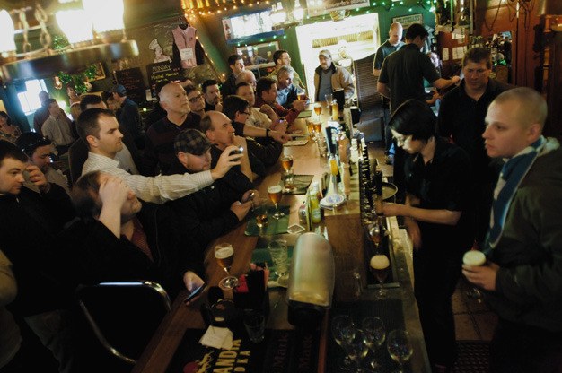 Beer enthusiasts crowd the bar at the Roanoke Inn to try the California-brewed “Pliny the Younger” beer on Monday afternoon. The rare and popular beer was gone in 17 minutes.