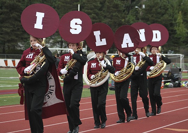 Members of the horn section of the Mercer Island marching band show their Island pride before kickoff of the football game against Bellevue High School on Friday