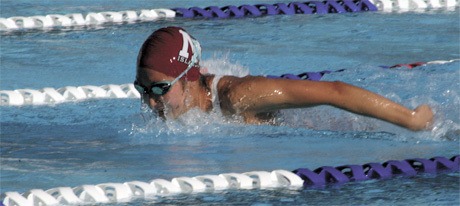 Islander freshman Danielle Deiparine heads down her lane during the breaststroke leg of the girls swimming 200-meter relay race. The Islanders won their first league match of the season against Newport.