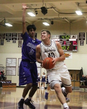 Mercer Island's Andrew Pickles (40) drives to the hoop past Lake Washington's Sahil Basra (3) Friday night at MIHS. The Kangs beat the Islanders 64-63.