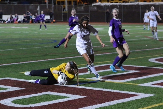 Mercer Island's Namya Malik chases a ball that's taken by Lake Washington keeper Mikaela Powers Wednesday night at Islander Stadium. The Islanders beat the Kangs 2-0.