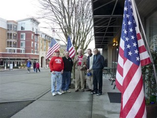 Kiwanians raise the American flag in downtown Mercer Island. The Kiwanians are