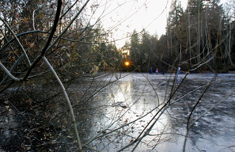 The evening sun sets over a frozen Ellis Pond on Friday