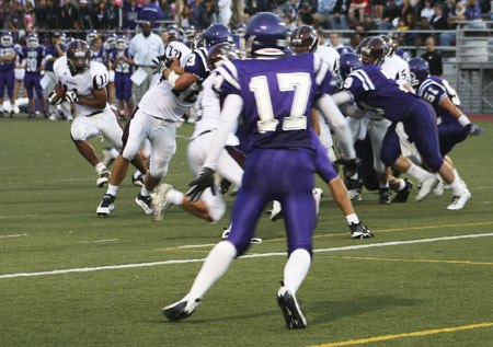 Senior running back Kurtis Rosengreen looks to get out from behind the Lake Washington defensive line in the Islanders first game of the season. Mercer Island won the game 14-7.