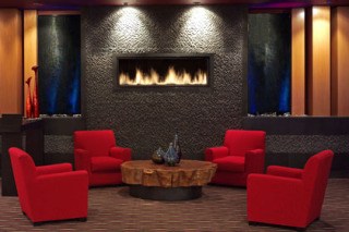 A seating area in the resort features an elevated fireplace.