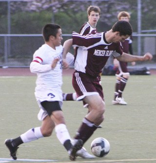Islander Diego Corvalan battles against a Juanita player during the last regular season game of the spring. The Islanders advance straight to the state tournament after clinching the KingCo title.