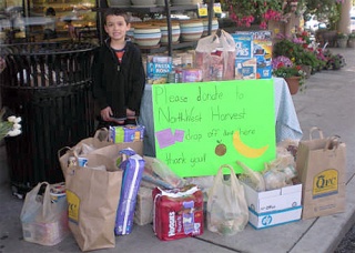 West Mercer second-grade student Noland Wittman collected food for Northwest Harvest as part of a class project. He gathered donations at the North-end QFC