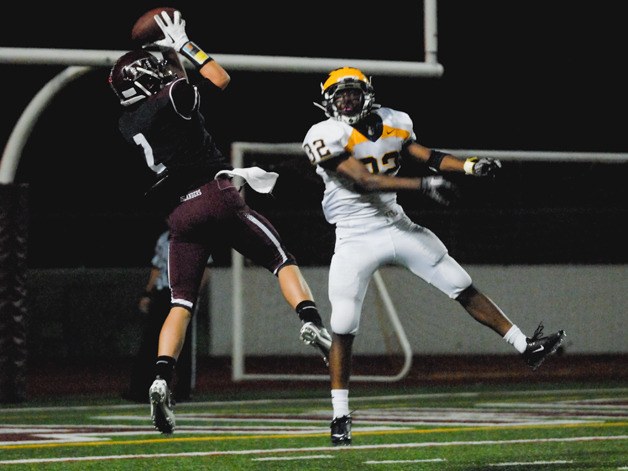 Islander WR Steen Swedstedt (2) catches a touchdown pass over Wolverine DB Bishard Baker (32) during the second half at Mercer Island on Friday. Bellevue won 43-28.