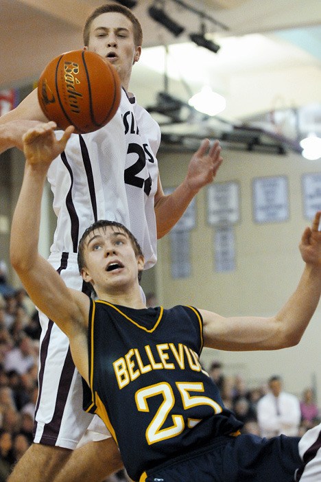 Islander forward Quinn Sterling blocks a shot attempt by Bellevue guard Will Locke (25) at Mercer Island on Friday. The Wolverines beat the Islanders 67-59 to remain undefeated on the season.