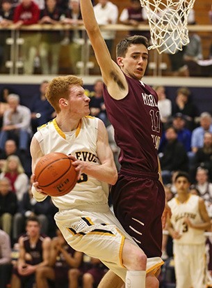 Mercer Island’s Sam Nordale goes up for the block against Bellevue’s Kyle Foreman Friday