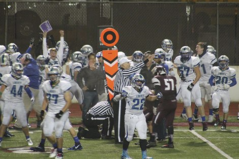 The Liberty sideline reacts after a Mercer Island fourth-down measurement comes up short of the first-down marker. The Patriots scored the winning touchdown on the next play