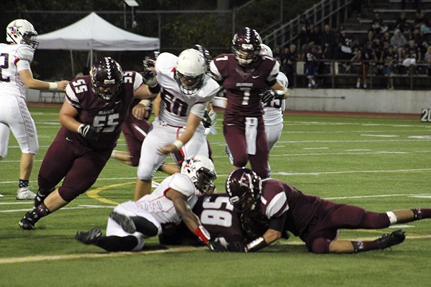 Mercer Island’s Trevor Himstead (58) recovers a fumbled snap by Juanita Friday at Islander Stadium. The Islanders fell to the Rebels