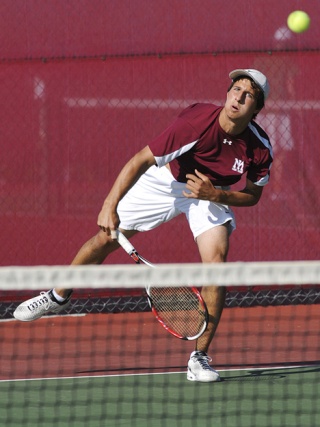 Islanders Matt Ellis serves against Woodinville at Mercer Island