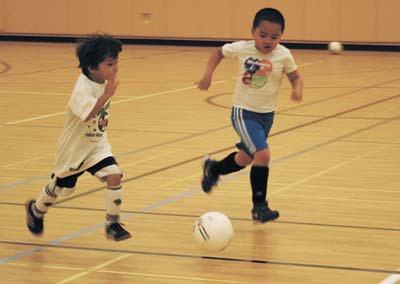 Youth soccer players in the Mercer Island indoor program held this week at PEAK sprint toward the goal during the morning practice.