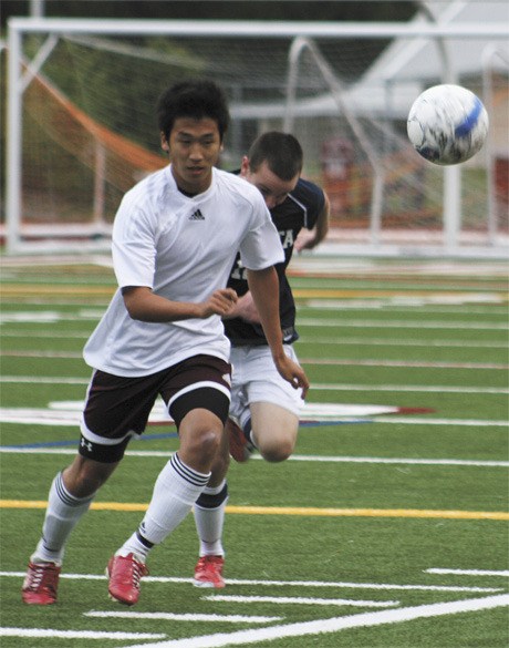 Mercer Island senior mid-fielder Jene Wook-Shin sprints to catch the ball before it goes out of bounds during the first half of the Islanders’ KingCo tournament game against Juanita.