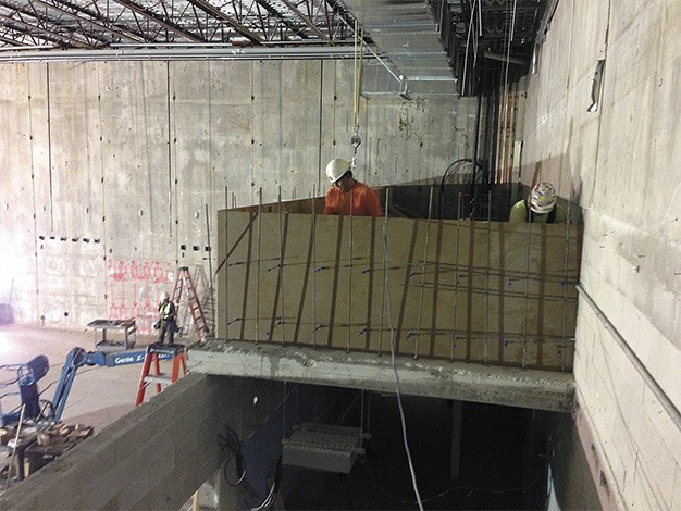 Members of the construction crew work on the new control room area at the Stroum Jewish Community Center.