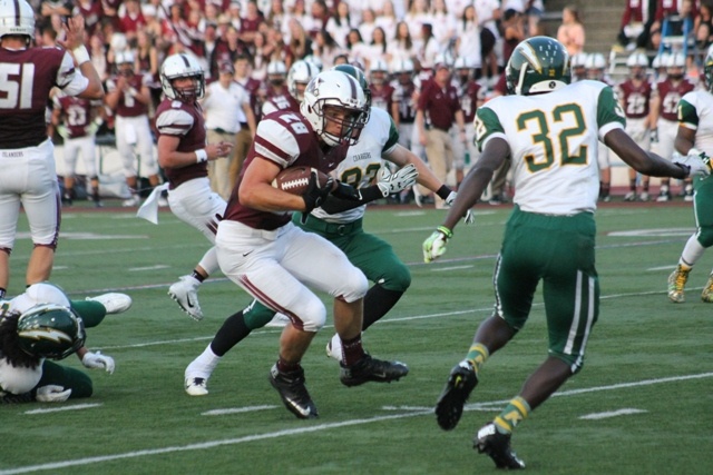 Mercer Island running back Jordano Mark (28) jukes his way through the Kentridge defense Friday night at Islander Stadium. Mark rushed for 144 yards on 25 carries as the Islanders beat the Chargers