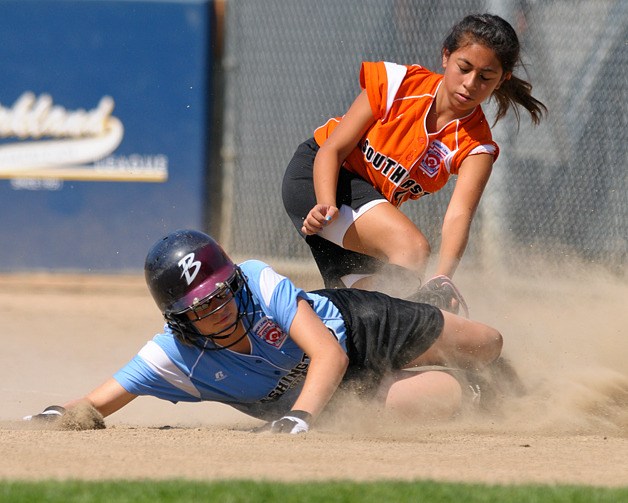 Washington base runner Claire McCarthy slides in safely to third base ahead of the tag by Southeast's Leilani Valenzuela during pool play of the Junior Softball World Series at Everest Park in Kirkland on Tuesday.