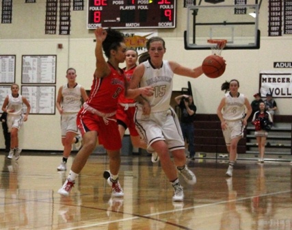 Mercer Island's Taylor Krause (15) drives past Juanita's Tea Adams (5) Friday