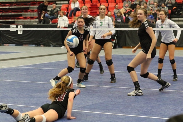 Mercer Island's Natalie Robinson dives for the save behind teammates Helena Shield (4) and Tessa Fisk during the Islanders' quarterfinal match against Shorewood Friday