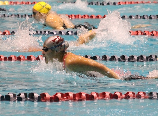 Mercer Island's Sabrina Kwan competes in the 100 fly during the 3A girls swim and dive state championships Saturday at King County Aquatic Center. Kwan won her third 100 fly state title with a time of 56.44.