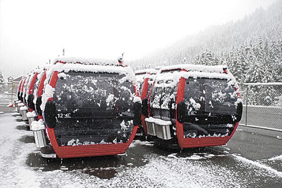 These shiny new gondola cars await their final installation on the new lift at Crystal Mountain. Each can hold eight skiers who will stash their gear in the carriers on the outside of the cars.