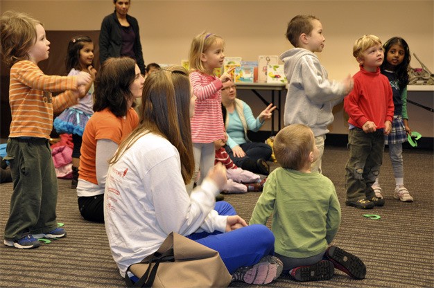 Children ages 3 to 5 sing and dance during the preschool story time with Margaret Martin