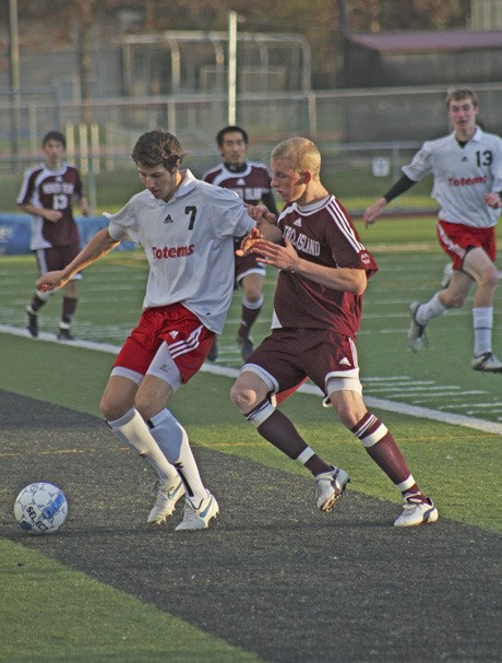 Sammamish’s Mitchell Rock protects the ball from Mercer Island defender Ari Langman during Tuesday’s game in Bellevue. The Islanders lost 2-1.