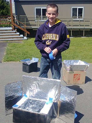 Islander student Leif Gullstad makes the final adjustments on his oven.