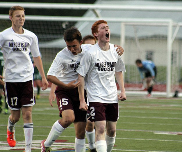 Derek Sims (no. 15) and Steven Woolston celebrate after Woolston's second-half goal against Shorecrest in the 3A state quarterfinal game Saturday