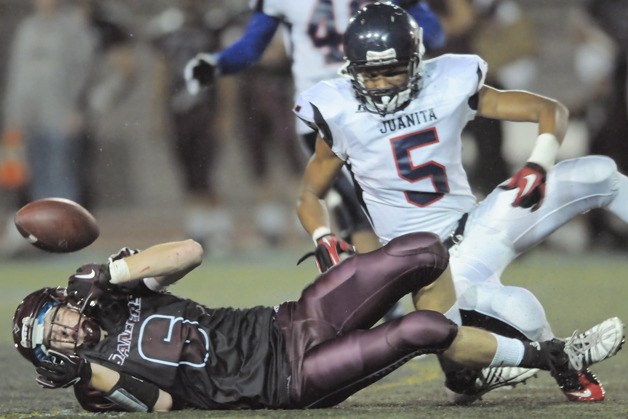 Juanita DB Andre Casino (5) knocks the ball loose from Mercer Island WR Alex Rorem (6) on a fourth and seven play in the fourth quarter during a 28-13 win by the Rebels.