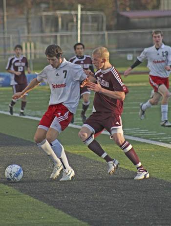 Sammamish's Mitchell Rock holds off Mercer Island defender Ari Langman during the Islanders away loss to Sammamish last Tuesday. Mercer Island fell 2-1.