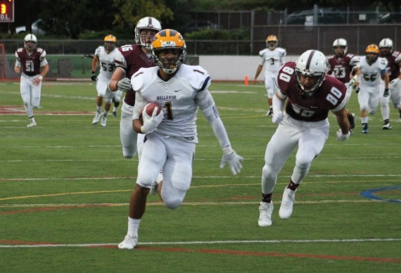 Bellevue's Isaiah Gilchrist (1) charges through the Mercer Island defense on a 35-yard touchdown pass from Justus Rogers Friday night at Islander Stadium. Bellevue beat Mercer Island