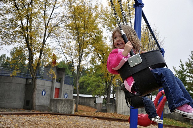 Children swing at Luther Burbank Park with the arrival of the new fall season.