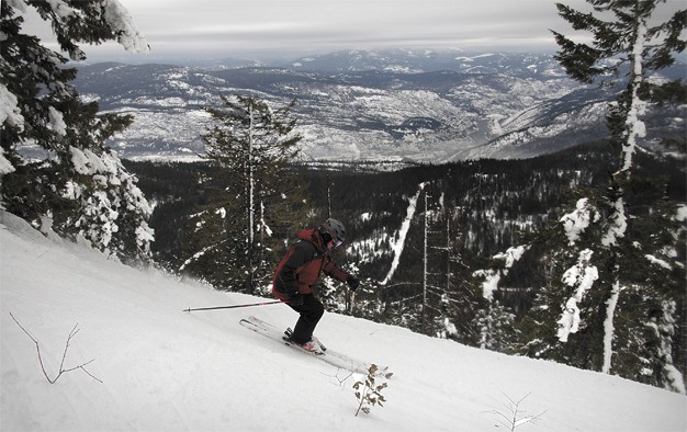 A skier enjoys the snow at Red Mountain.