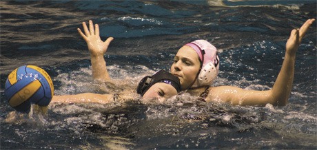 Senior captain Stephanie Hammond stops an OAC player on defense during the Islanders’ water polo win last week.