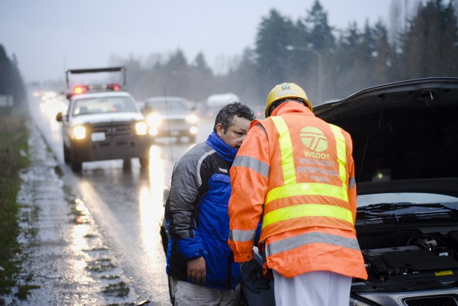 WSDOT Incident Response Team maintenance technician Pat Nolan assists motorists with disabled vehicles along I-405 near Kirkland on November 30