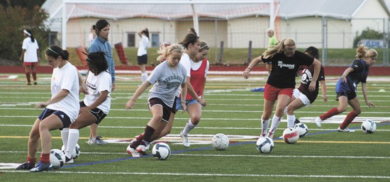 Members of the MIHS girls varsity soccer team go through practice drills last week.