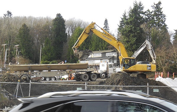 Contractors remove tons of dirt from the site of the Legacy project in the 2600 block of 76th Place S.E.