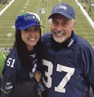 Covenant Shores Chaplain and Seahawks fan Greg Asimakoupoulos poses at a game with his daughter