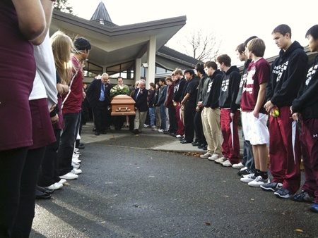 Members of the Mercer Island High School boys and girls tennis teams lined the exit to the Mercer Island Prysbetarian Church on Saturday