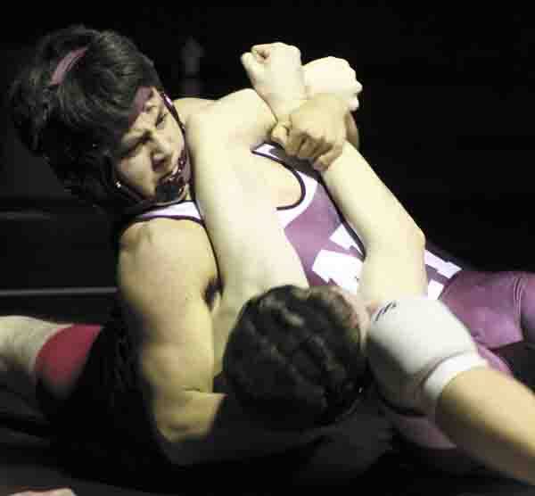 Kenji Walker gets a lock on Sammamish's David Bloomsburg in the 130 weight class during the Islanders home win over the Totems last Thursday.