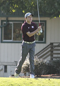 Mercer Island's Zach Evens follows his shot after teeing off against Liberty Thursday